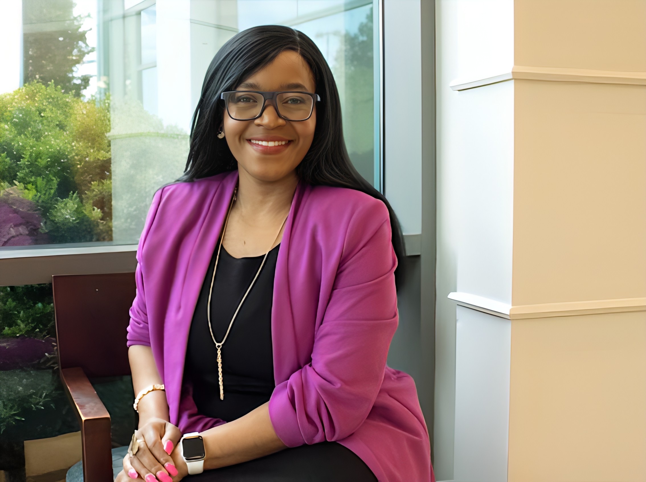 Portrait of Dr. Lilly Mbinglo seated by a window