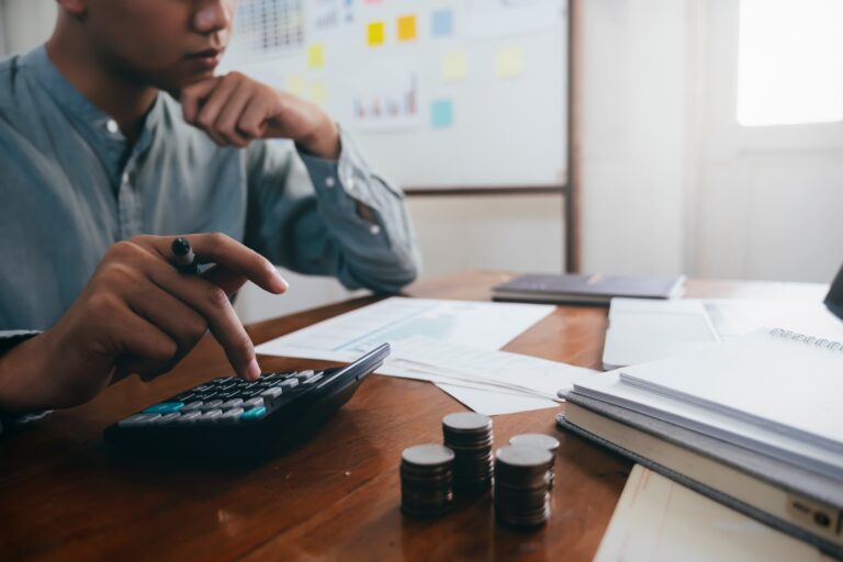 Closeup accountant using calculator.